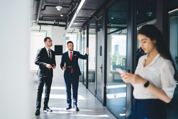 Thoughtful diverse colleagues in office corridor
