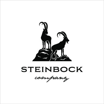 Two steinbock standing on a rock cliff with a classic design