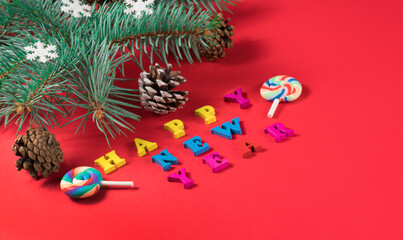 Top view of shiny Christmas decoration and thuja on red background with happy new year lettering