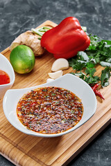 Many different spices, vegetables and ingredients, and fresh herbs for making homemade sauce