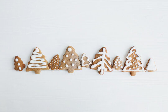 Tasty minimalist homemade gingerbread christmas tree cookies with icing