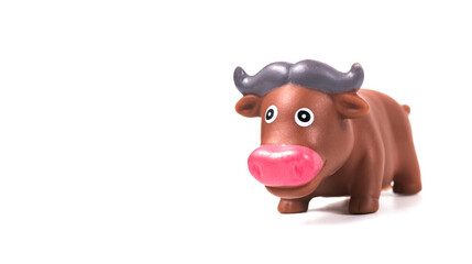Toy bull made of plastic on a white background