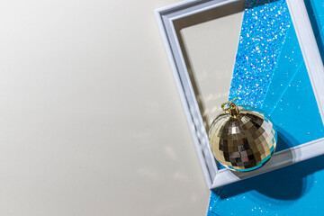 Christmas mirror balls on a shiny background. Hard light with shadows.