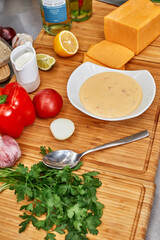 Many different spices, vegetables and ingredients, and fresh herbs for making homemade sauce