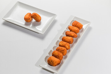 Fried Spanish ham Croquettes over a white background
