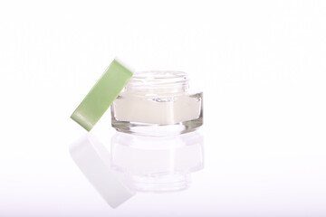 Premium cosmetic glass jar with moisturizing cream isolated on white background. Hydrating and softening skin, beauty, skin care routine, skip-care, natural cosmetic products, dermatology copy space