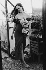 Portrait girl with long hair in the greenhouse. Walk in the flower garden. Girl and flowers