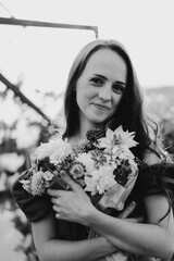 Portrait girl with long hair in the greenhouse. Walk in the flower garden. Girl and flowers