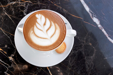 Big cappuccino cup on cafe table. Hot coffee on table