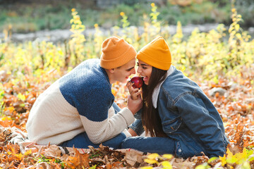 Couple in love enjoying autumn. Fashionable couple on a walk in nature. Love, relashionship and lifestyle.