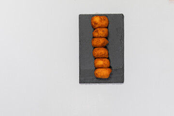 Fried Spanish ham Croquettes over a white background