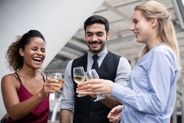 Group of business people celebrate by drinking wine.
