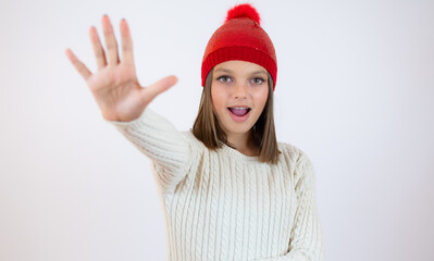 Close up portrait of a girl showing stop gesture with her palm isolated over white background