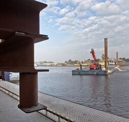 Pontoon with tugboat in harbour. Ship building industry. Netherlands. Shipyard.