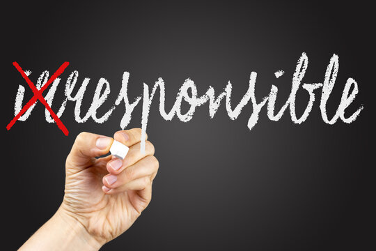 Сrossed out letters to write responsible. Doodle on a blackboard, written with white chalk in a hand. 