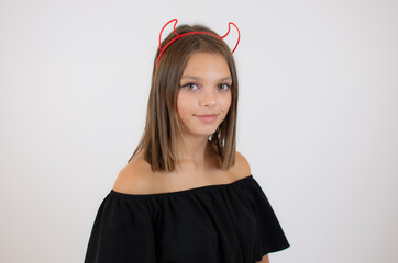 Image of happy young girl dressed in crazy cat halloween costume over white background.