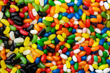 Multi-colored glazed sweets in large quantities. View from above.