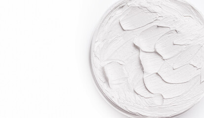 Cream texture close-up on a white background, top view. Copy space