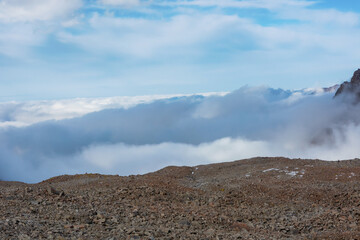 Mountain landscape view in Kyrgyzstan. Rocks, snow and stones in mountain valley view. Mountain panorama.