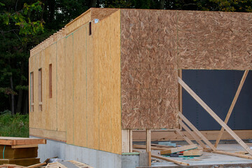 corner of the construction site of a new plywood house