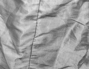 Abstract background of white fabric is creased. Texture of fabric creased in black and white tone.