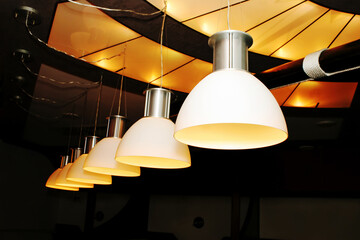 Lighting lamps in the billiard room. Modern polymer lights hang on the ceiling. View from below