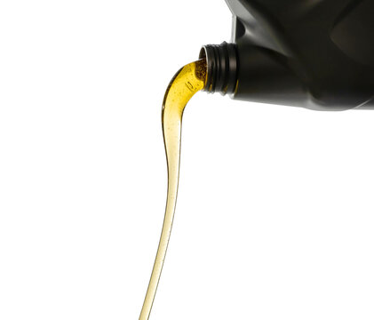 Pouring Fresh Automotive Engine Oil (lubricating Oil, Yellow Liquid Oil) Into A Motor Car Isolated On White Background. Change New Oil. Maintenance, Service, And Energy Fuel Concept. .