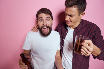 Two men drink beer friendship drunk alcohol lifestyle pink background