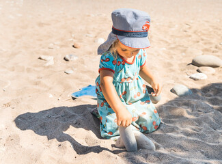 Toddler girl playing on beach