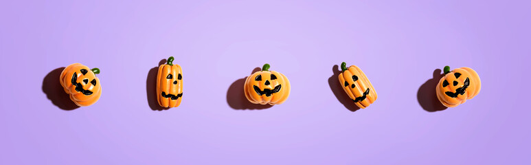 Miniature Halloween pumpkin ghosts - overhead view flat lay