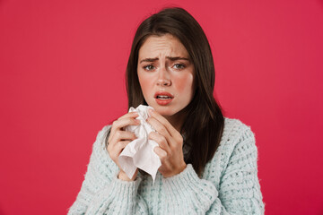 Image of unhappy beautiful girl with flu holding napkin