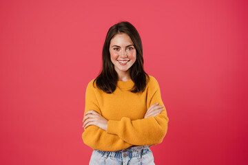 Fototapeta premium Image of happy beautiful girl posing with arms crossed