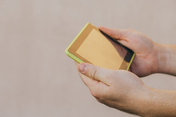 shot of male hands holding modern tablet pc mock-up outdoors