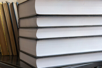 A stack of large thick books is on the shelf, Focus Stacking