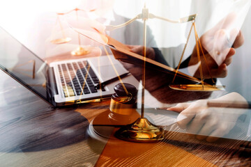 Business and lawyers discussing contract papers with brass scale on desk in office. Law, legal services, advice, justice and law concept picture with film grain effect