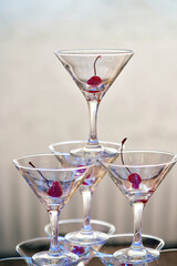 Pyramid of glass goblets with red cherry inside