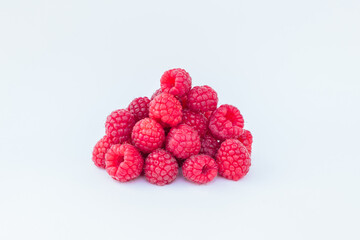 appetizing raspberries on a white background, a bunch of juicy ripe fresh berries