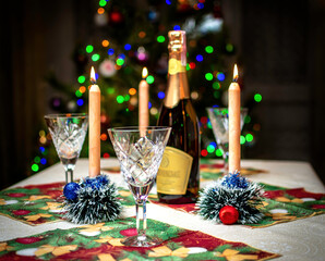 Champagne, glasses, candle and Christmas decorations