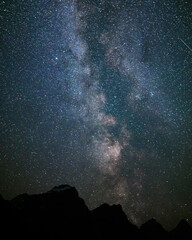 The Milky Way over the mountains and Moraine Lake in Alberta, Canada