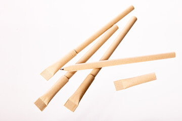 Reusable eco-friendly craft paper pens isolated on white background. Writing ballpoint pen, environmental protection, ecology, natural materials, recycling concept. Copy text space