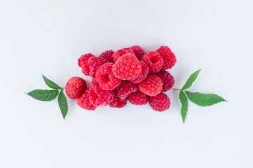 appetizing raspberries on a white background, a bunch of juicy ripe fresh berries