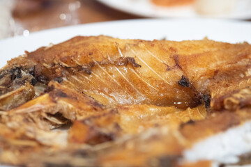 Deep fried fish with fishsauce on the white plate