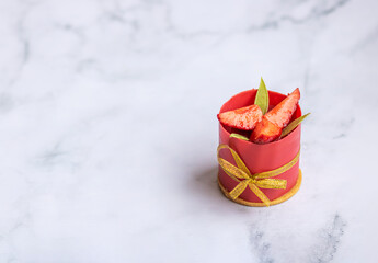 Dessert made by slice of strawberries and chocolate on marble background with copy space.