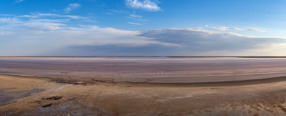 Sunset on the Genichesk pink extremely salty lake (colored by microalgae with crystalline salt depositions), Ukraine.