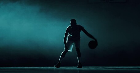 Cinematic slow motion back view shot of young professional male players are walking towards a basket before to start practicing a basketball work out in a gym.