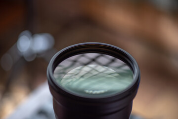 Photo lens photographed in the studio close-up on a dark background.