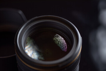 Photo lens photographed in the studio close-up on a dark background.