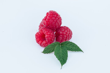 appetizing raspberries on a white background, a bunch of juicy ripe fresh berries