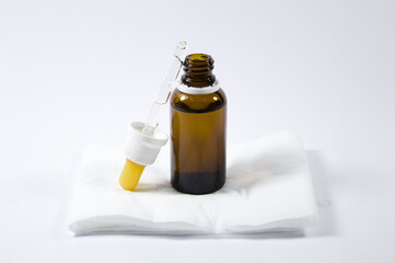 Dropper with glass ampoule and white and gray background