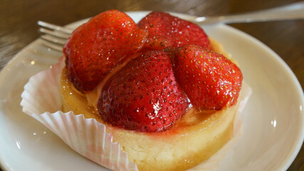 Photography of a delicious tartlet with strawberries. Theme how to get good mood at the morning....
